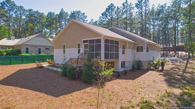 45 Martin Dr, Whispering Pines, NC 28327 - rear view of house featuring a sunroom