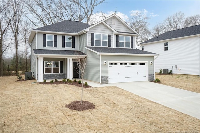 view of front of house featuring central AC, driveway, an attached garage, and a shingled roof