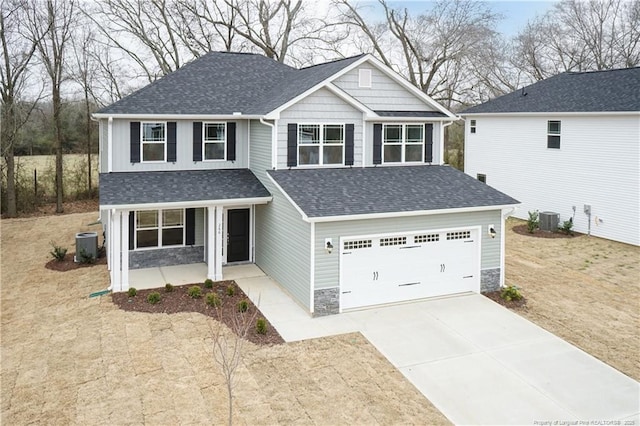 craftsman-style home with concrete driveway, a shingled roof, and cooling unit