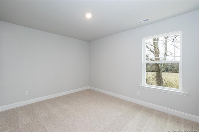 empty room with light colored carpet, baseboards, visible vents, and recessed lighting