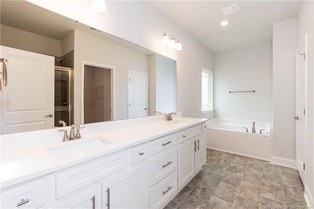full bath with a sink, a stall shower, a garden tub, and visible vents