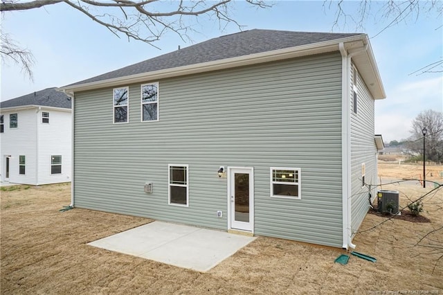 rear view of house with a yard, a patio, and cooling unit