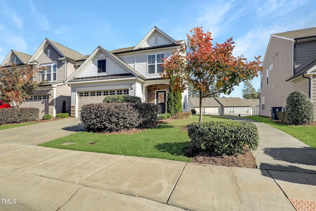 craftsman inspired home featuring an attached garage, driveway, stone siding, and a front yard