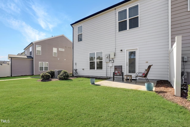 back of property featuring a yard and a patio