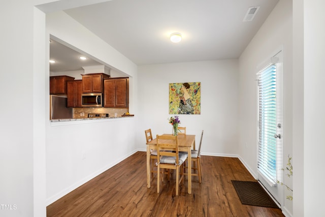 dining space with baseboards, visible vents, recessed lighting, and dark wood-style floors