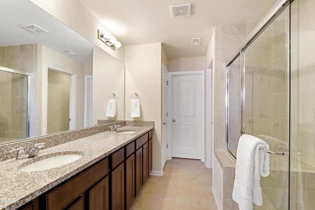 bathroom with a sink, visible vents, and a stall shower