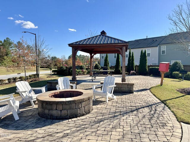 view of patio with a fire pit and a gazebo