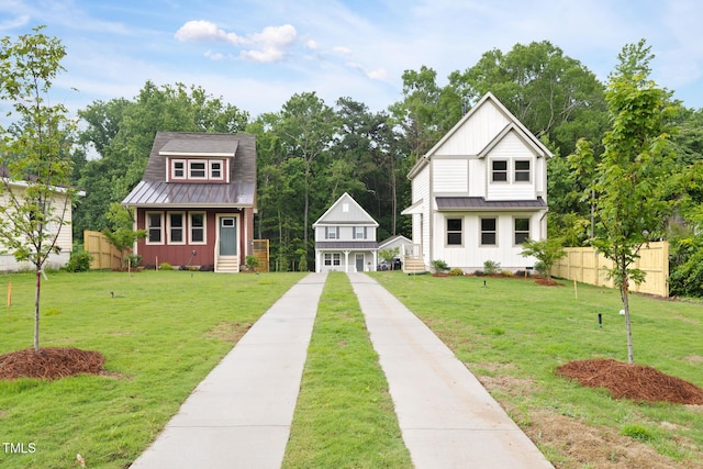 1448A Maplewood Dr, Durham, NC 27704 - view of front of property featuring board and batten siding, metal roof, a standing seam roof, and an outdoor structure