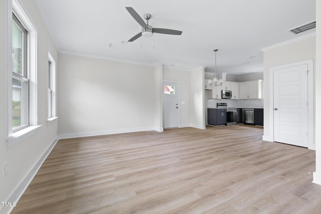 1448A Maplewood Dr, Durham, NC 27704 - unfurnished living room with plenty of natural light, a chandelier, ornamental molding, ceiling fan, and baseboards