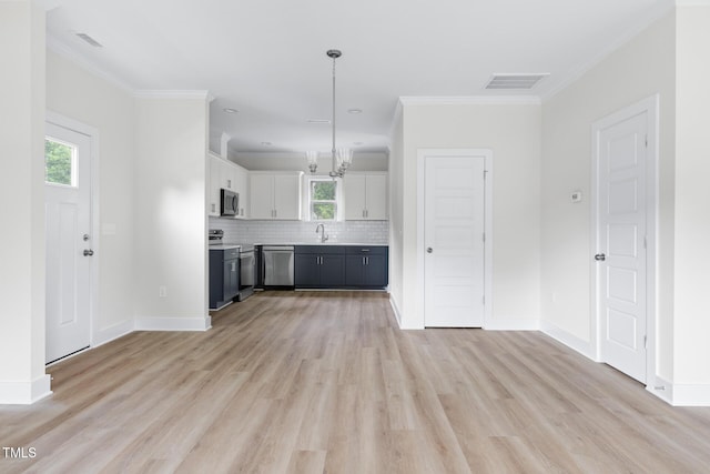 1448A Maplewood Dr, Durham, NC 27704 - unfurnished living room featuring a sink, light wood-style flooring, crown molding, baseboards, and a chandelier