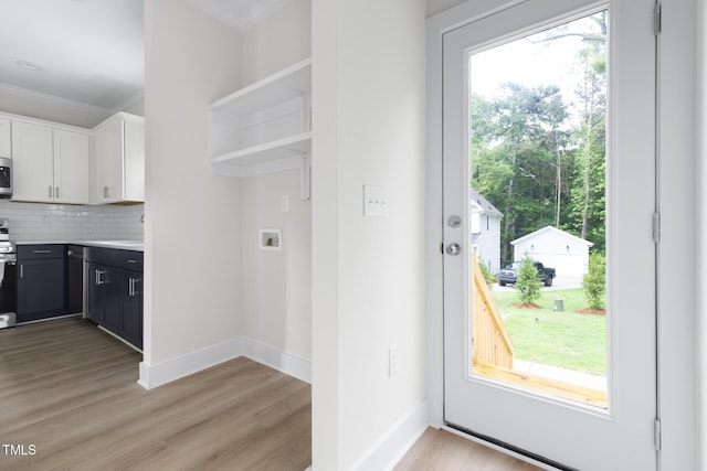1448A Maplewood Dr, Durham, NC 27704 - washroom featuring crown molding, washer hookup, light wood-type flooring, and baseboards