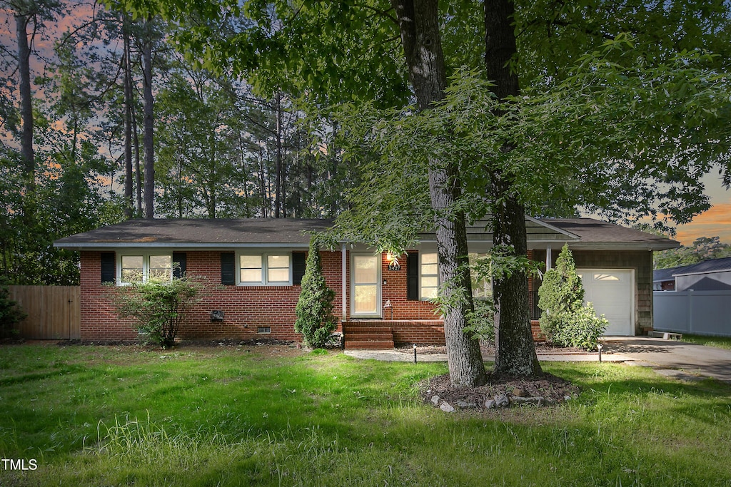 3427 Rogers Dr, Fayetteville, NC 28303 - single story home with an attached garage, crawl space, fence, and concrete driveway