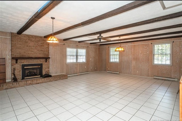 unfurnished living room with wood walls, a baseboard radiator, and a healthy amount of sunlight