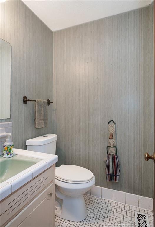 half bathroom featuring toilet and vanity