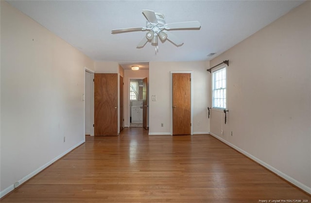 empty room with light wood-style flooring, baseboards, and ceiling fan