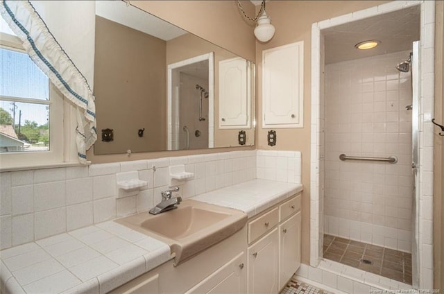bathroom featuring vanity, tasteful backsplash, and a stall shower