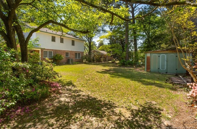 view of yard featuring a storage unit, central AC, and an outbuilding