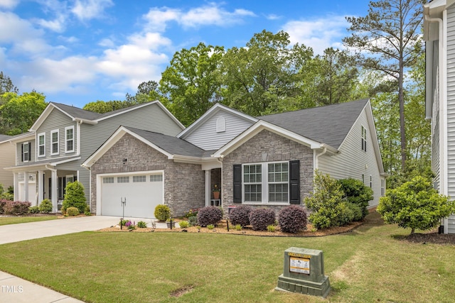 view of front of property featuring stone siding, driveway, a garage, and a front yard