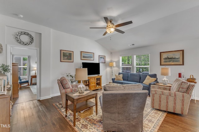 living room featuring lofted ceiling, wood finished floors, ceiling fan, and baseboards