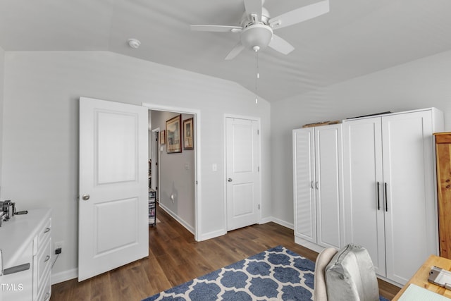 bedroom featuring vaulted ceiling, dark wood-style flooring, baseboards, and a ceiling fan