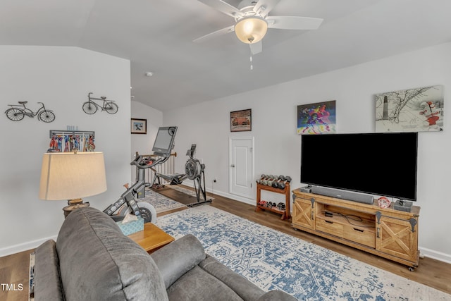 living area featuring vaulted ceiling, baseboards, a ceiling fan, and wood finished floors