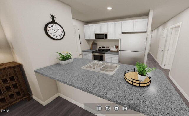 224 Landon Pl, Roxboro, NC 27573 - kitchen featuring dark wood-style flooring, white cabinetry, baseboards, a peninsula, and appliances with stainless steel finishes
