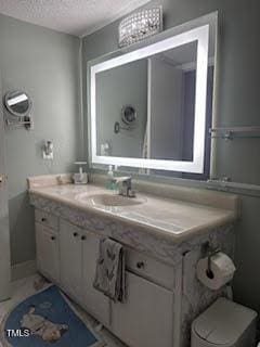 bathroom featuring vanity and a textured ceiling