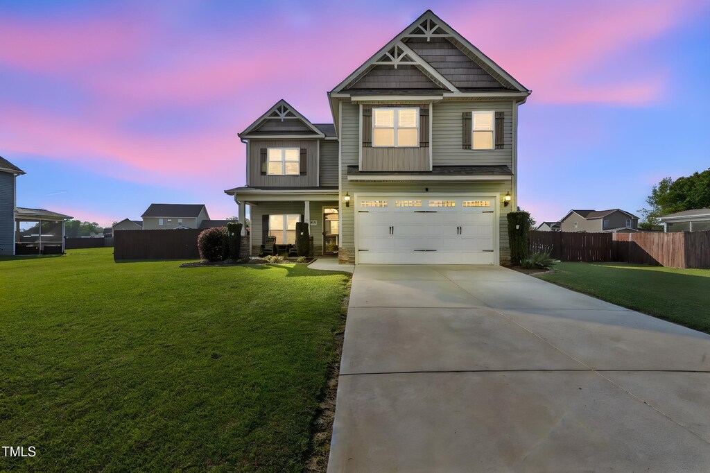 207 Ingram Fields Dr, Goldsboro, NC 27530 - craftsman-style house featuring a garage, concrete driveway, a front yard, and fence