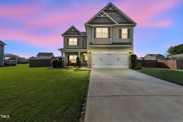 craftsman-style house featuring a garage, concrete driveway, a front yard, and fence