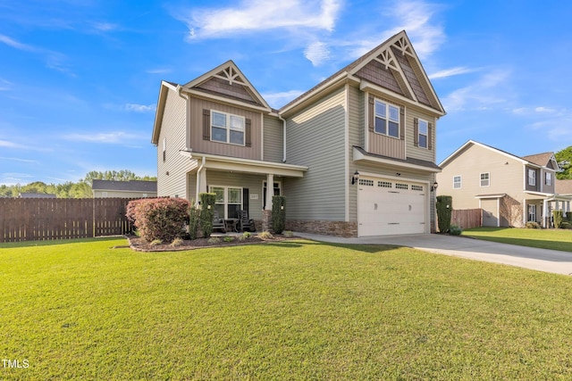 craftsman-style house featuring a front lawn, concrete driveway, fence, an attached garage, and board and batten siding