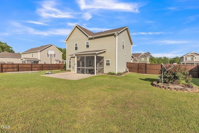 rear view of house featuring a yard, a patio area, a sunroom, and a fenced backyard