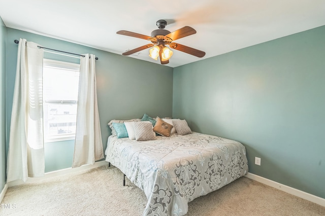 carpeted bedroom featuring ceiling fan and baseboards