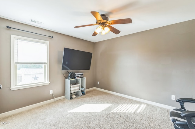 interior space with baseboards, visible vents, and ceiling fan