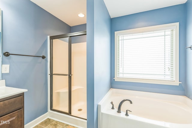 bathroom with a bath, vanity, a wealth of natural light, and a shower stall