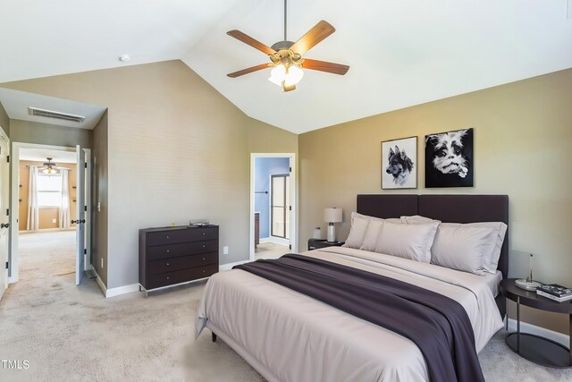 bedroom with baseboards, visible vents, light colored carpet, ensuite bath, and high vaulted ceiling