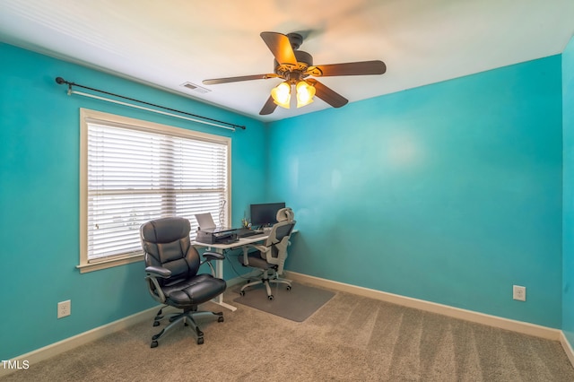 office space with ceiling fan, carpet floors, visible vents, and baseboards