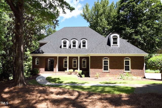 5504 Spring Bluffs Ln, Raleigh, NC 27606 - view of front of property featuring brick siding, covered porch, and roof with shingles