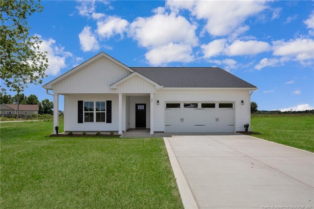 5566 Philippi Church Rd, Raeford, NC 28376 - view of front of property with an attached garage, concrete driveway, a front lawn, and covered porch