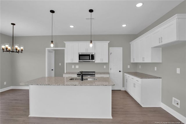 5566 Philippi Church Rd, Raeford, NC 28376 - kitchen featuring appliances with stainless steel finishes, a sink, a chandelier, baseboards, and white cabinets