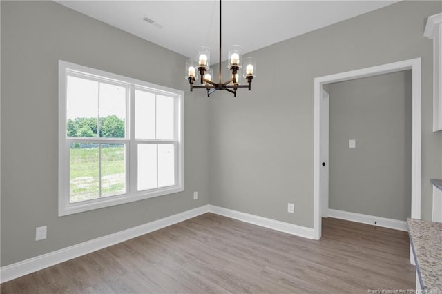 5566 Philippi Church Rd, Raeford, NC 28376 - empty room with a chandelier, wood finished floors, and baseboards
