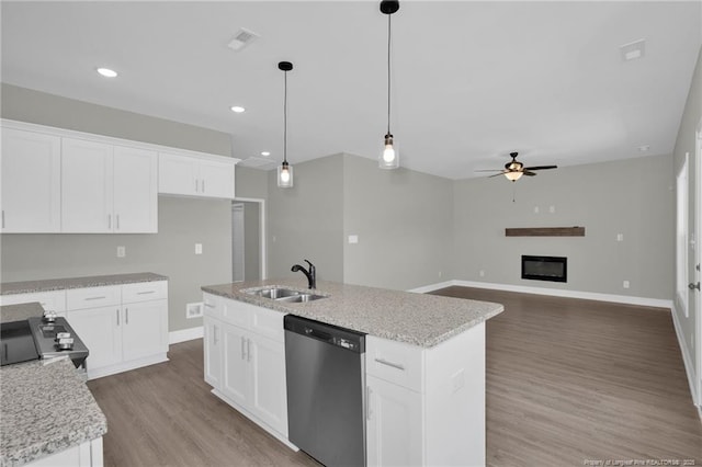 5566 Philippi Church Rd, Raeford, NC 28376 - kitchen with appliances with stainless steel finishes, a sink, ceiling fan, wood finished floors, and a kitchen island with sink