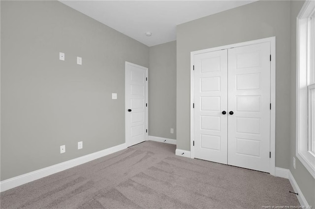 5566 Philippi Church Rd, Raeford, NC 28376 - unfurnished bedroom featuring carpet, a closet, and baseboards