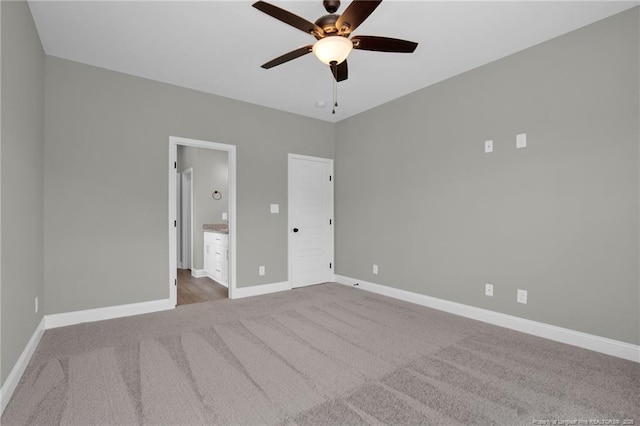 5566 Philippi Church Rd, Raeford, NC 28376 - unfurnished bedroom featuring carpet floors, baseboards, connected bathroom, and ceiling fan