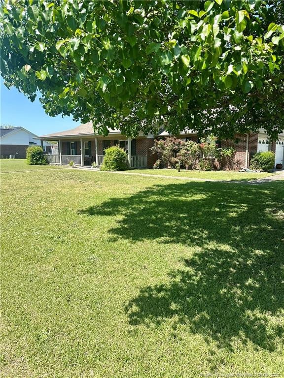 view of yard featuring covered porch