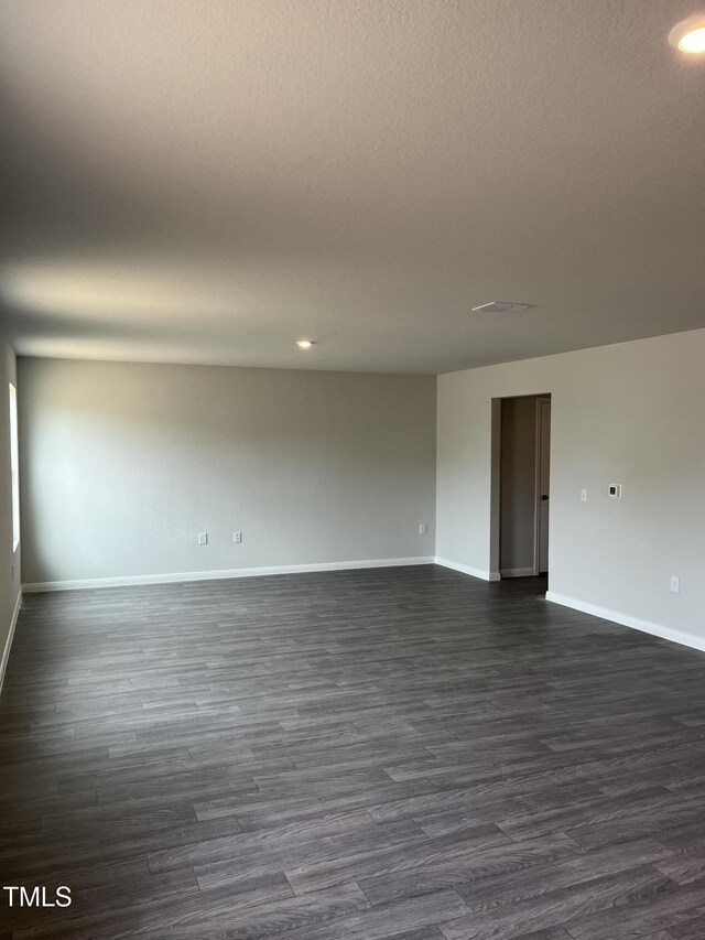 209 Lillian Ct, Roxboro, NC 27573 - unfurnished room featuring baseboards, dark wood-style floors, and recessed lighting