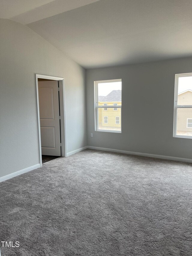 209 Lillian Ct, Roxboro, NC 27573 - carpeted empty room featuring vaulted ceiling and baseboards