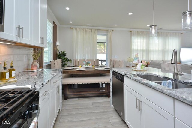 490 Mallard Loop Dr, Clayton, NC 27527 - kitchen featuring ornamental molding, a sink, tasteful backsplash, appliances with stainless steel finishes, and white cabinetry