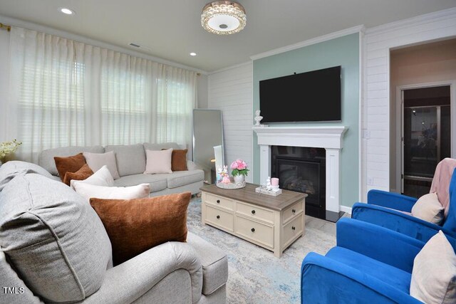 490 Mallard Loop Dr, Clayton, NC 27527 - living room with recessed lighting, visible vents, crown molding, a glass covered fireplace, and light wood-style flooring
