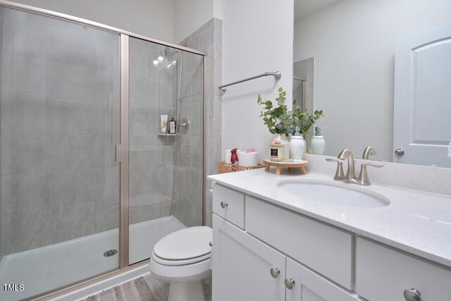 490 Mallard Loop Dr, Clayton, NC 27527 - bathroom featuring wood finished floors, vanity, a shower stall, and toilet