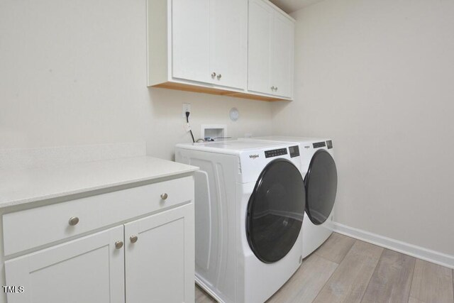 490 Mallard Loop Dr, Clayton, NC 27527 - laundry area featuring light wood finished floors, baseboards, independent washer and dryer, and cabinet space